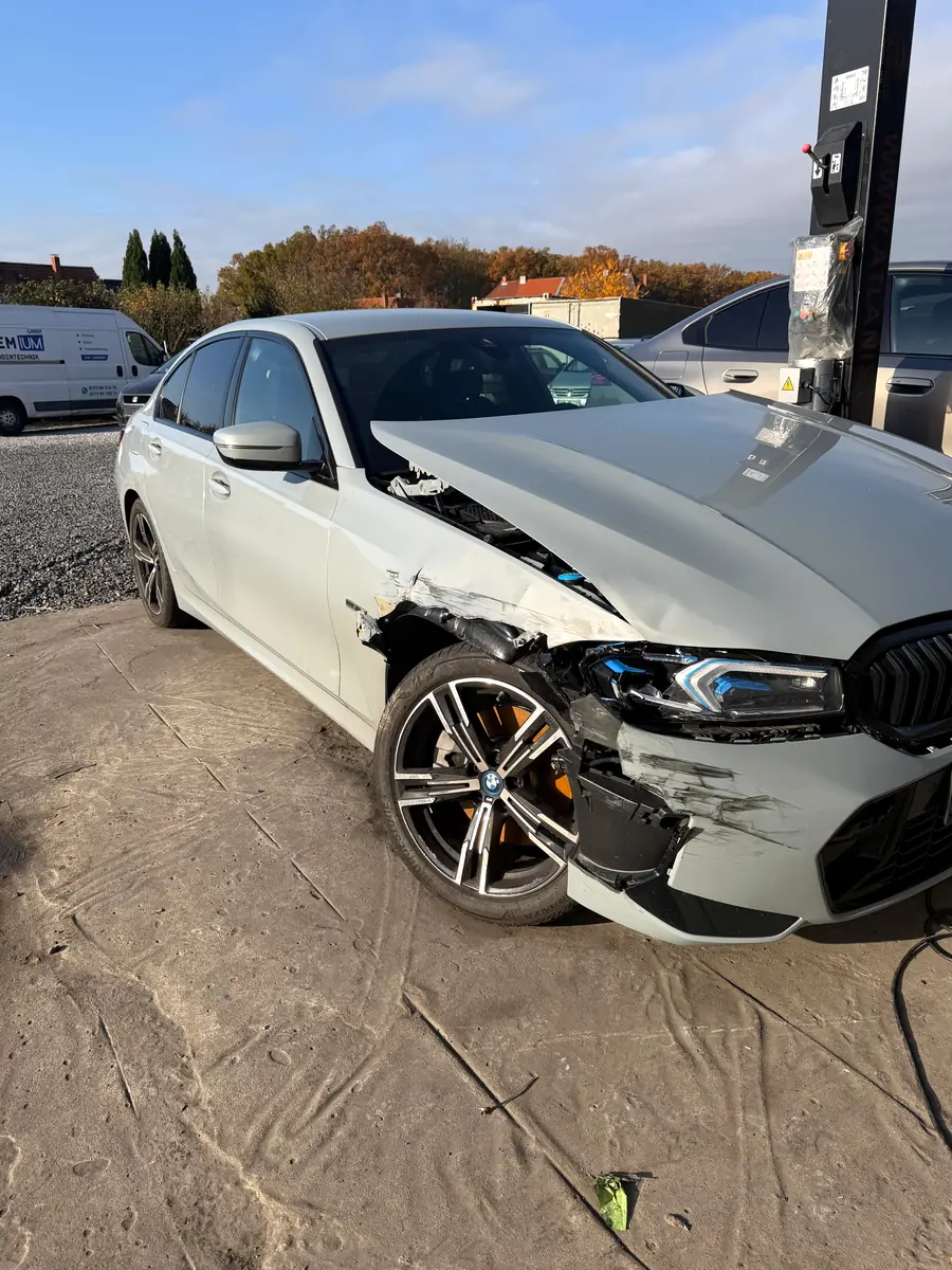 Grauer BMW 3er mit schwerem Frontschaden, Stoßstange und Kotflügel aufgerissen